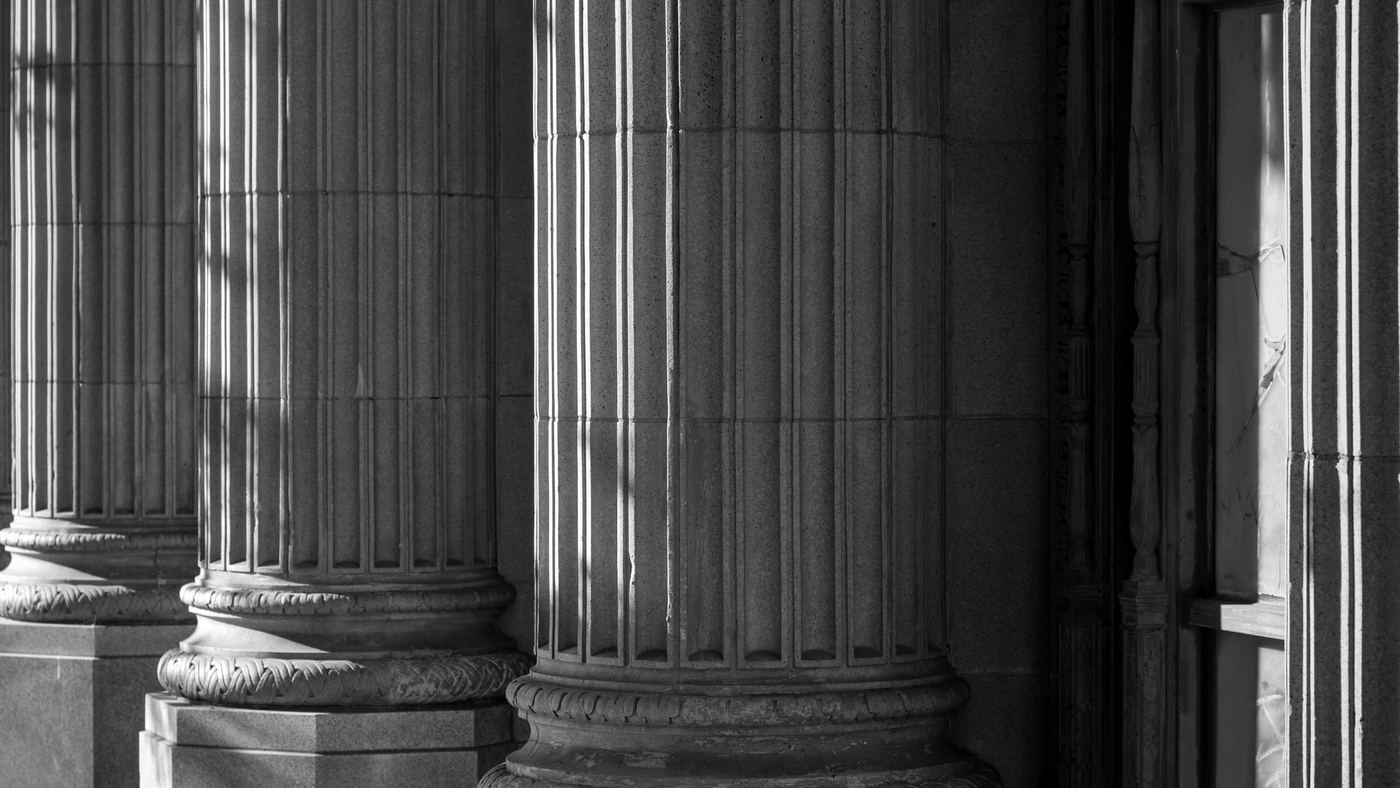 Fluted stone columns in low sunlight